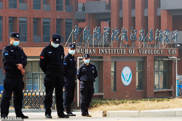 Pictured: Security personnel keep watch outside Wuhan Institute of Virology during the visit by the World Health Organization (WHO) team in February